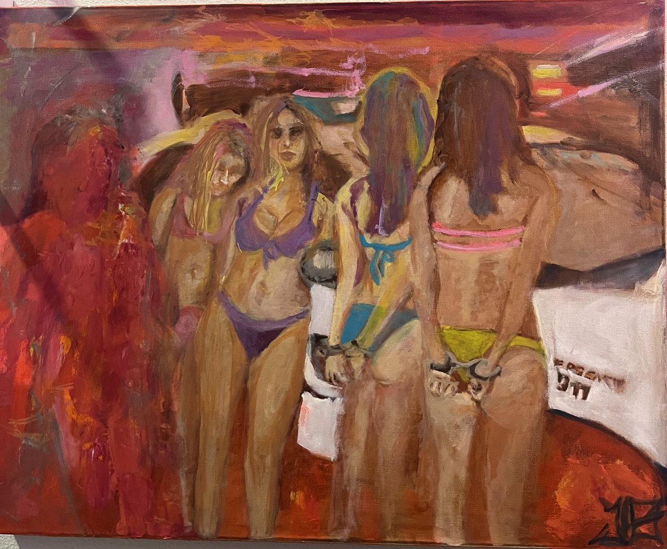 Four women in bikinis, handcuffed, on a fiery red ground