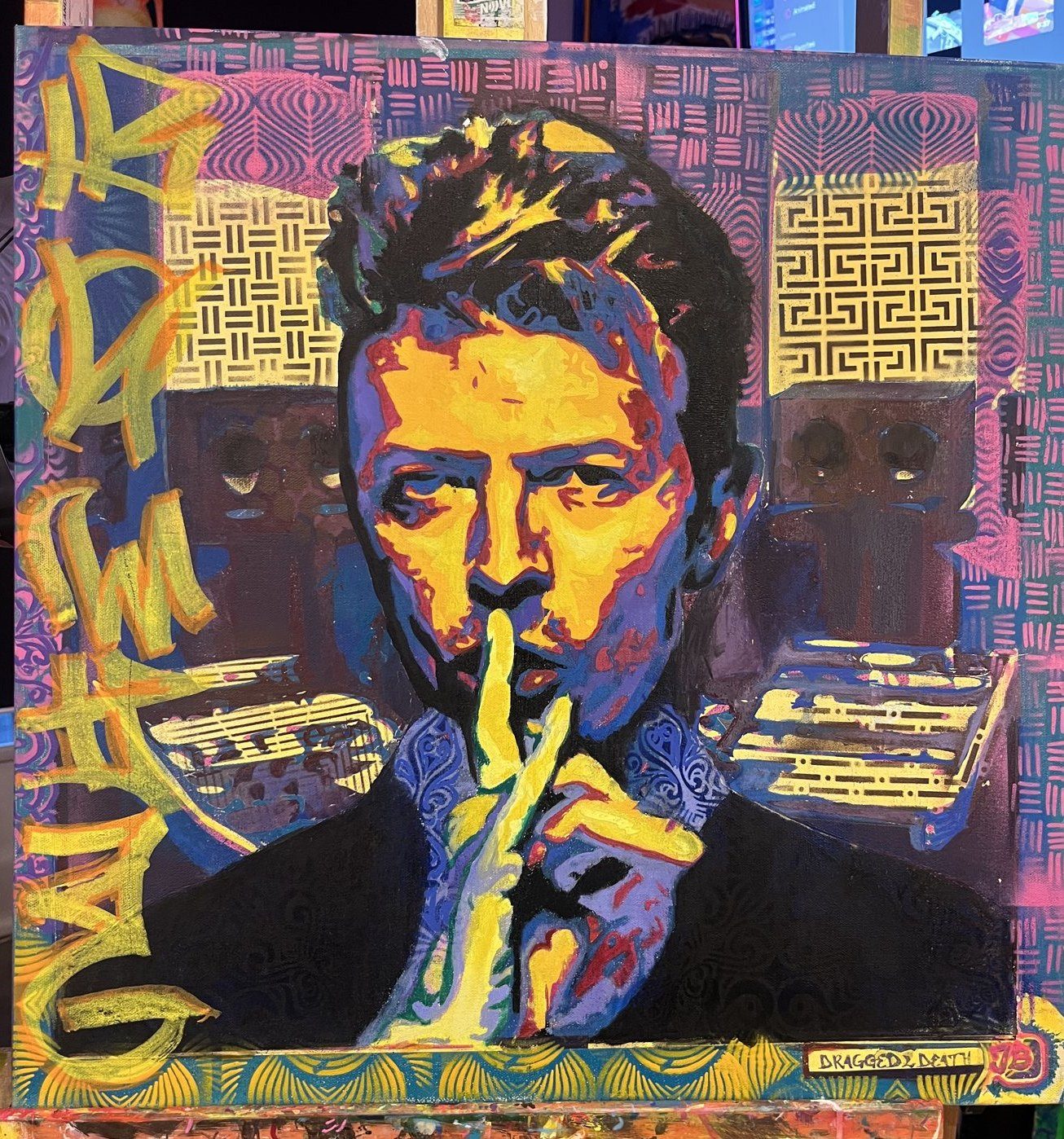 A man raising a finger to his lips, in electric blue, orange and purple pattern